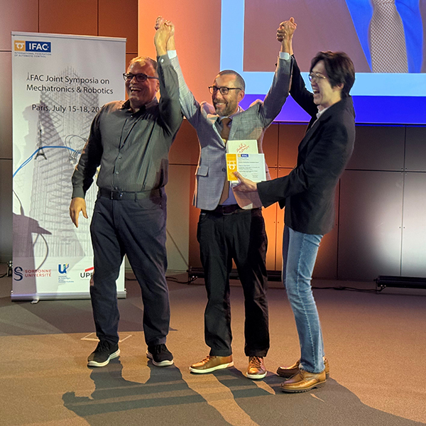 UCI Samueli School of Engineering Dean Magnus Egerstedt (center) is presented with the 2025 Robotics Outstanding Investigator Award by Professors Reza Moheimani, left, (UT Dallas) and Kyoungchul Kong (KAIST), IFAC Awards Committee chairs.