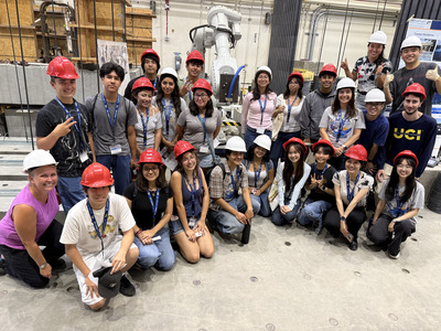 Students pose in red hard hats at Mo Li's lab at UC Irvine.